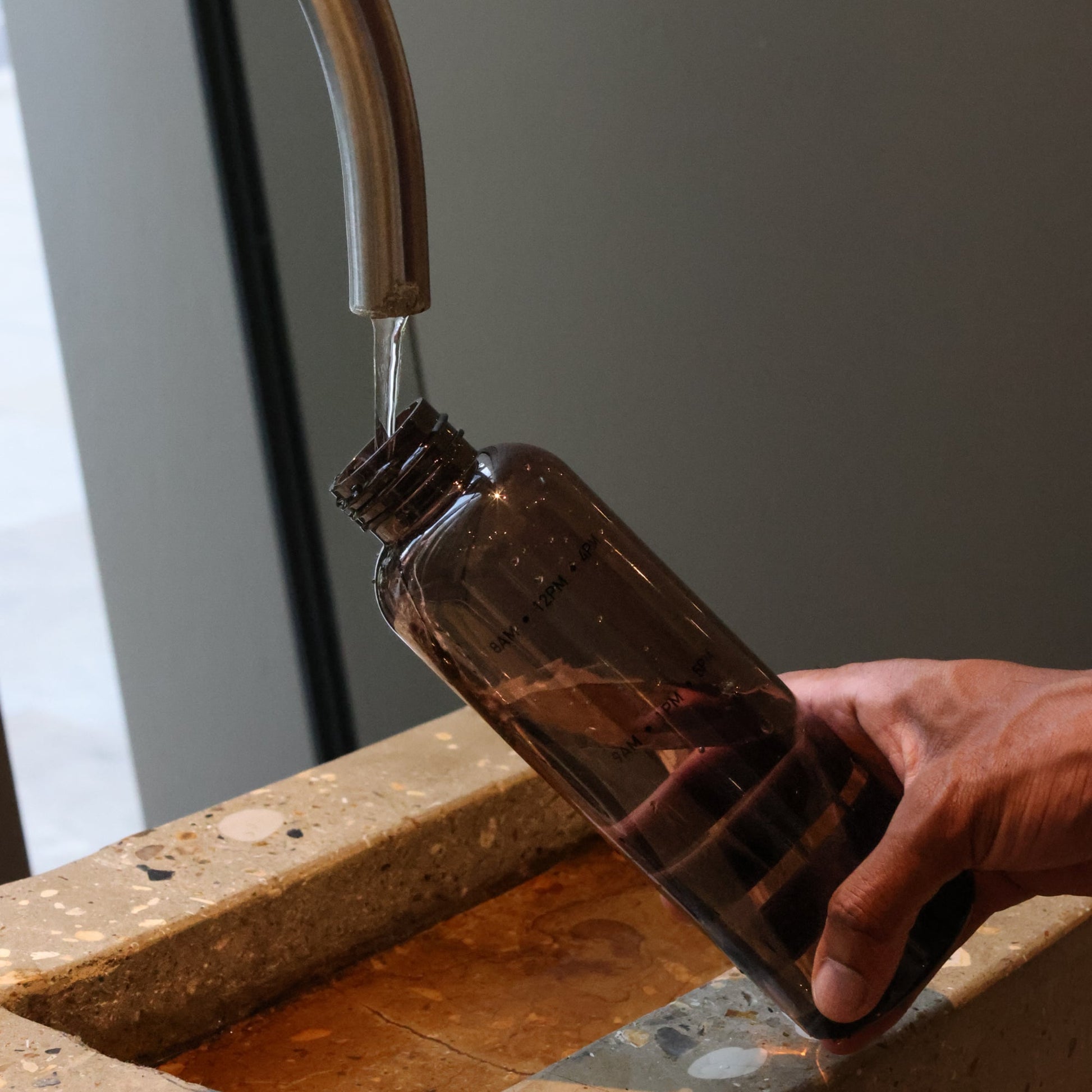 Small reusable water bottle for handbag with time marked detail. A good water bottle that can serve as a visual reminder to drink more water when not thirsty